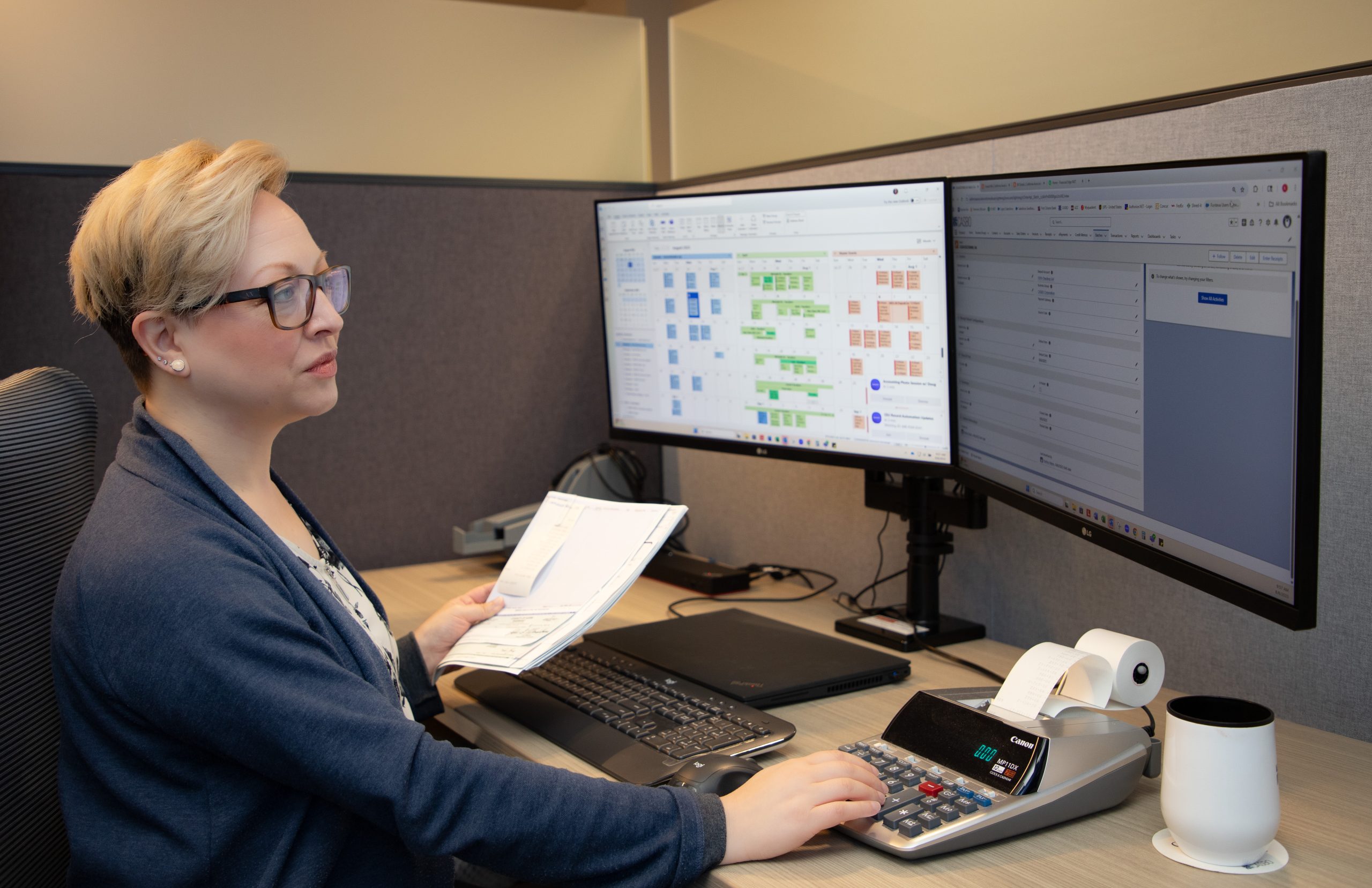 woman sitting at desk with calculator